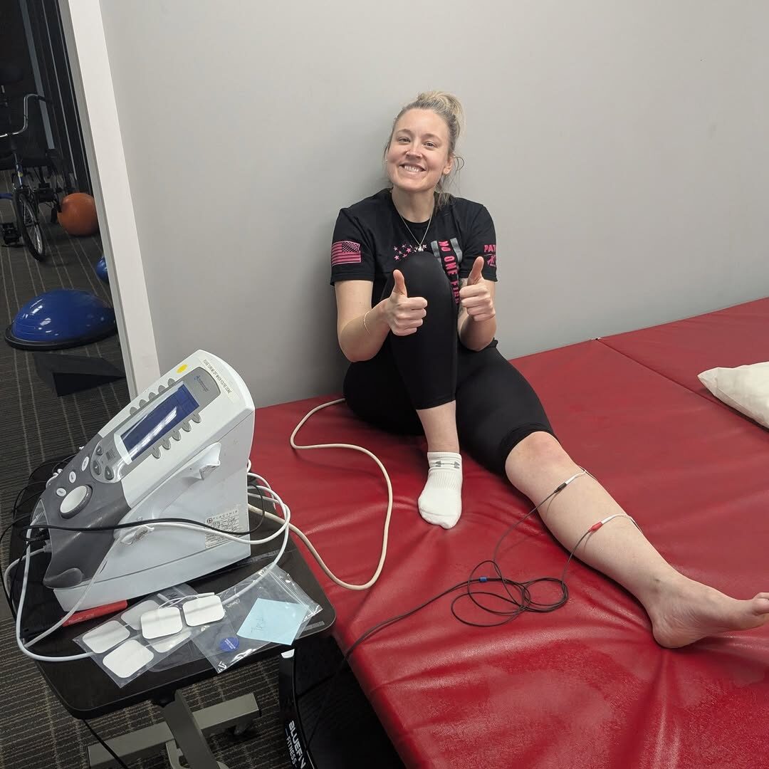 A patient giving a thumbs up while trying the new estim and ultrasound unit.